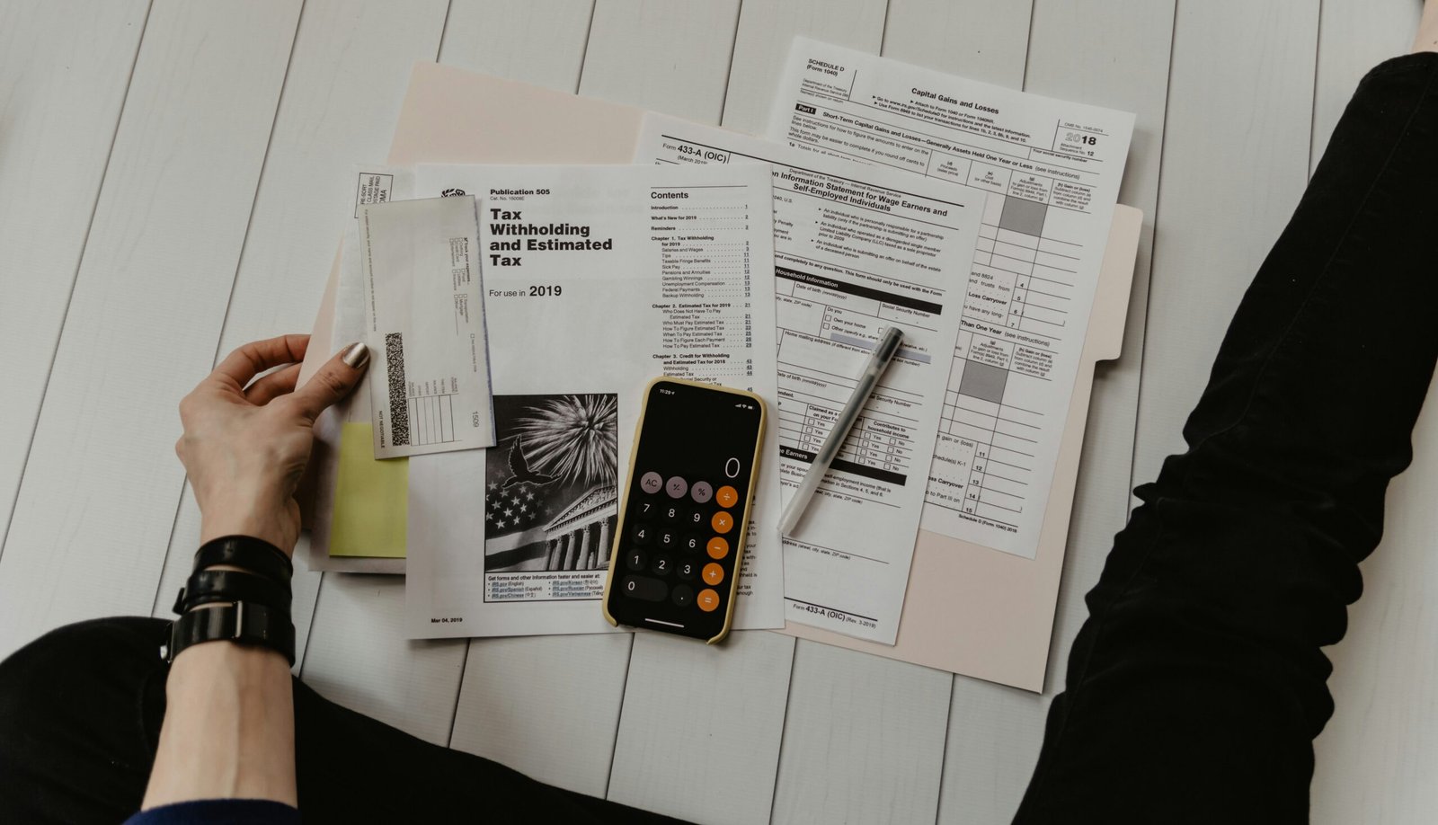A professional desk showing financial documents and a calculator representing claim denial management processes.