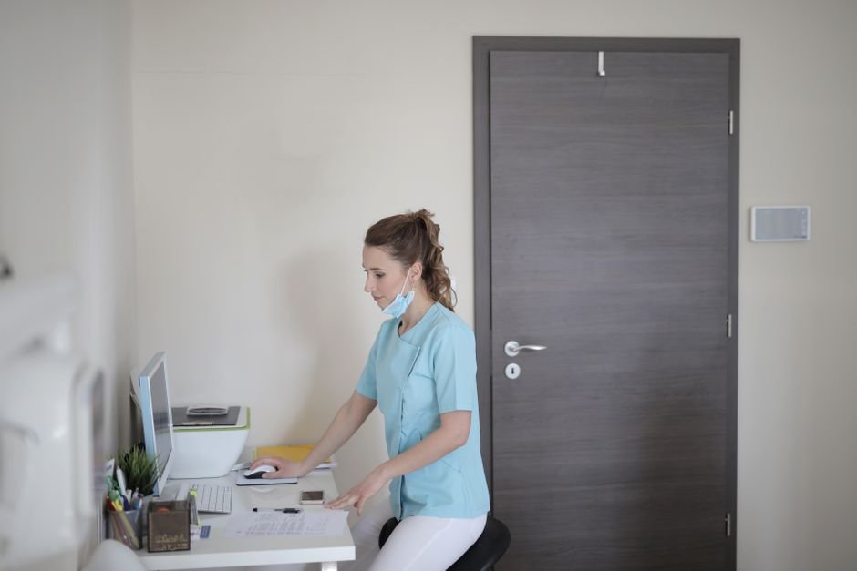 Medical billing specialist reviewing chiropractic billing codes and claim acceptance reports