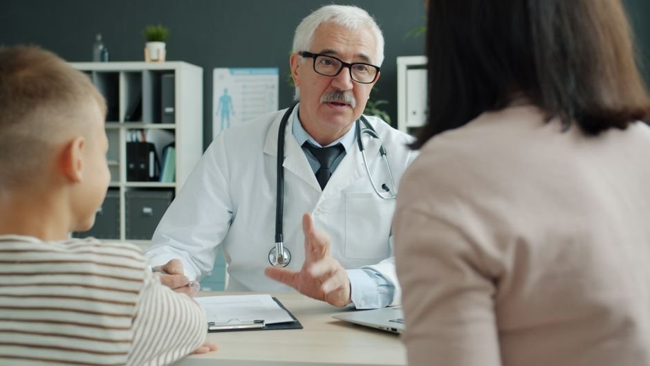 Healthcare professional discussing hospice billing options with an elderly couple in a calm office.