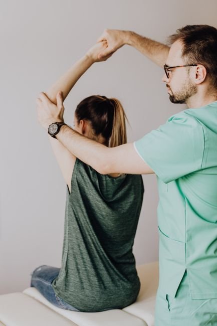 Chiropractor performing patient consultation and spinal assessment for chiropractic billing