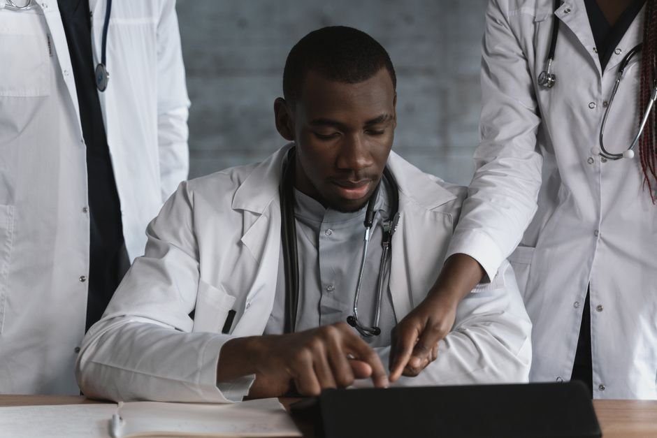 A medical team collaboratively analyzing data and healthcare technology to optimize wound care billing efficiency.