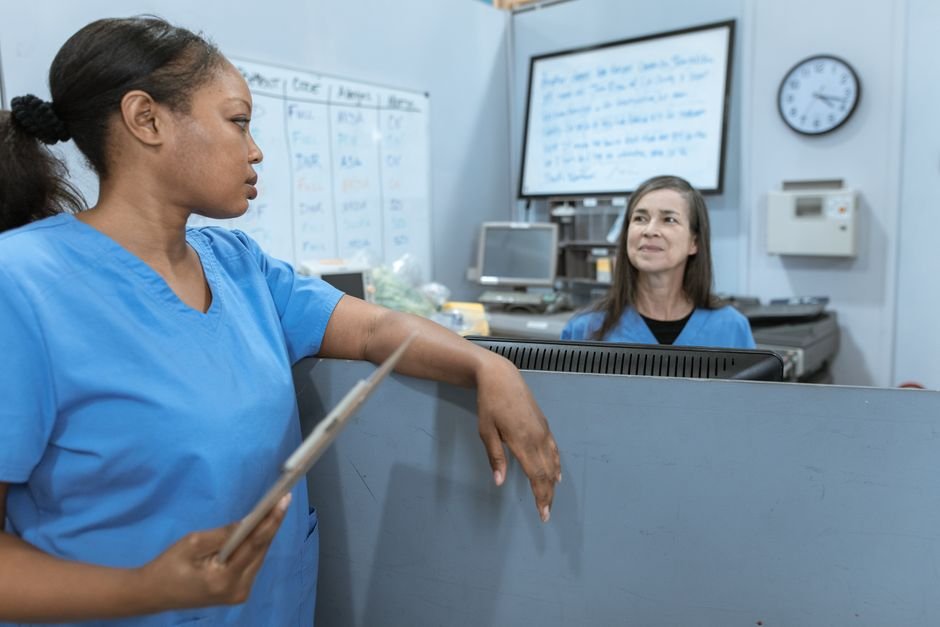 A healthcare provider and administrative staff discussing billing adjustments and patient accounts.