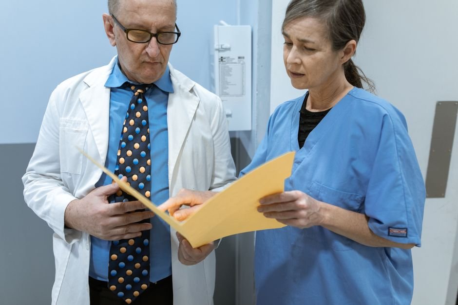 pexels photo 6129658.jpg Healthcare professionals collaboratively reviewing a complex billing workflow on a digital tablet.