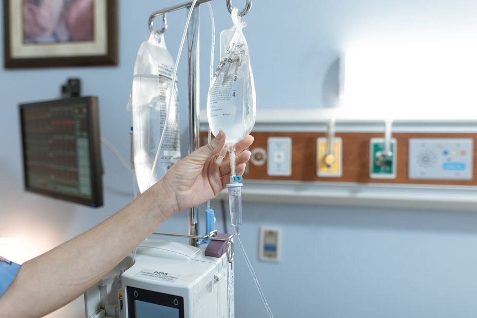 pexels photo 6129691.jpg A patient receiving IV infusion therapy in a modern medical facility with a nurse monitoring vitals.