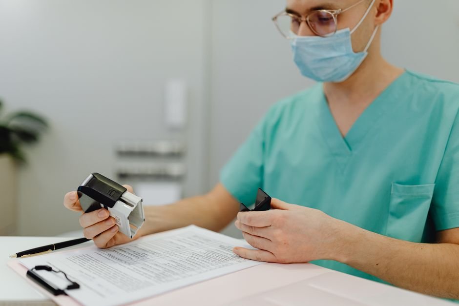 pexels photo 6627938.jpg Healthcare worker meticulously reviewing patient files for durable medical equipment documentation.