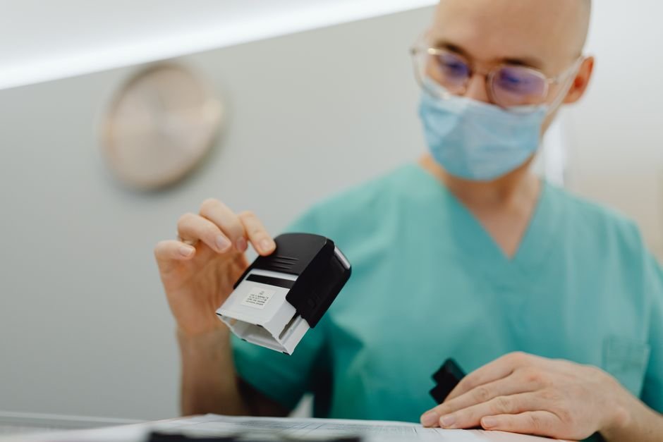 pexels photo 6627939.jpg Healthcare billing professional organizing medical documents for durable medical equipment claims.