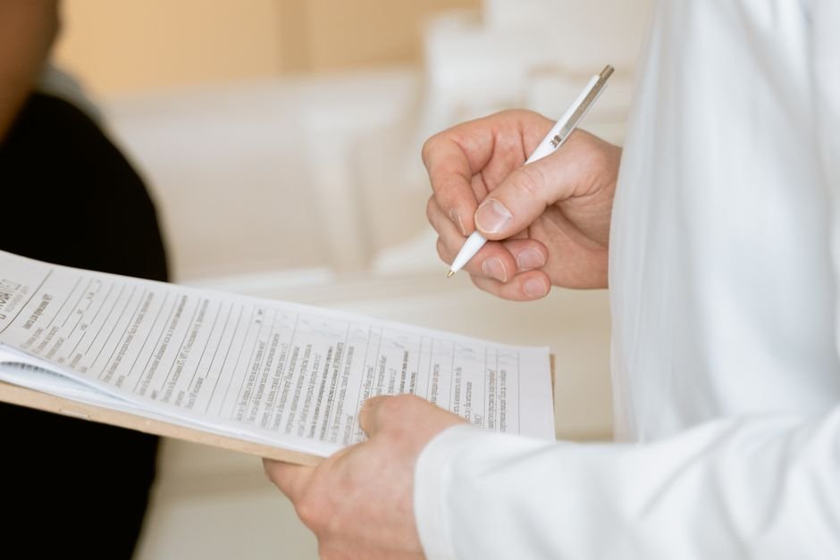 Occupational therapist reviewing patient charts and medical documents to ensure accurate billing.
