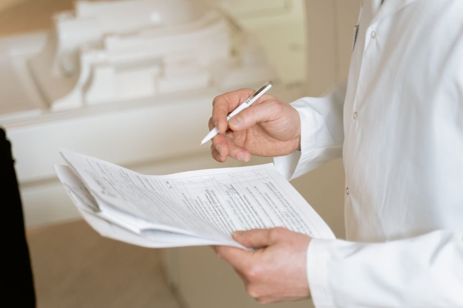 Medical professional meticulously reviewing urology billing documents for accuracy and compliance
