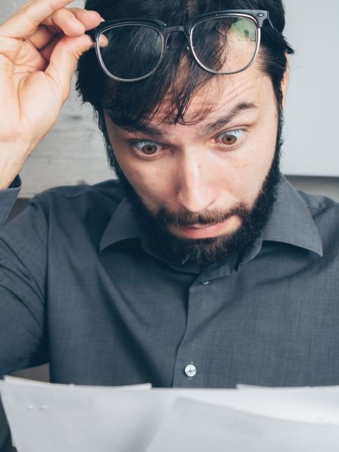 pexels photo 7534785.jpg A surprised man reviewing behavioral health billing claims on a tablet.