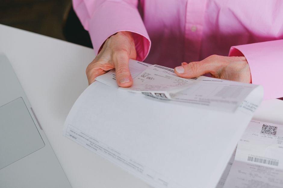 Medical billing specialist reviewing complex codes and patient documents carefully