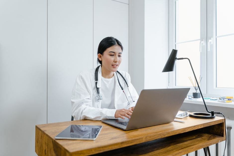 Healthcare professional using advanced technology to improve medical billing efficiency in a modern office