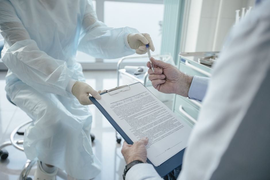 pexels photo 8413294.jpg Medical professionals review a crucial payer contract, highlighting the importance of payer contract negotiation.