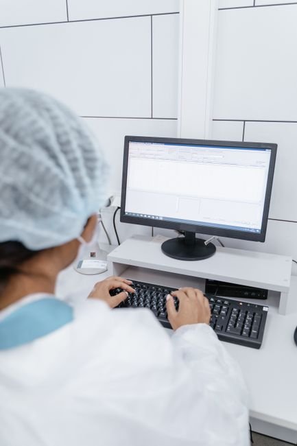pexels photo 9574482.jpg Medical professional diligently entering OASIS data into a computer system