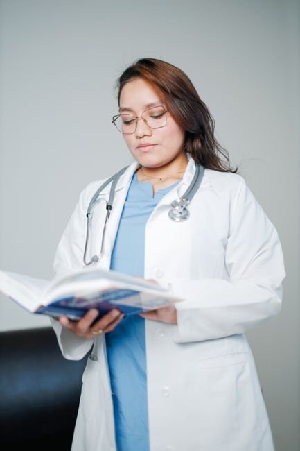 pexels photo 32254668.jpg Medical coder carefully reviewing a CPT code book on a desk for accurate virtual visit billing.