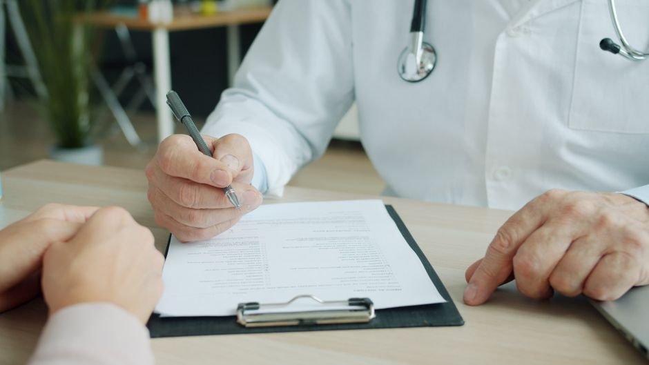 pexels photo 39192334.jpg Medical professional explaining health insurance forms to patient, clarifying Medicare Advantage billing.