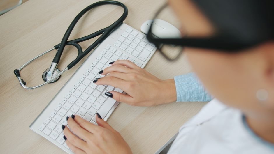 pexels photo 39192381.jpg Doctor uses computer keyboard with stethoscope nearby, representing efficient healthcare IT for MA plans.