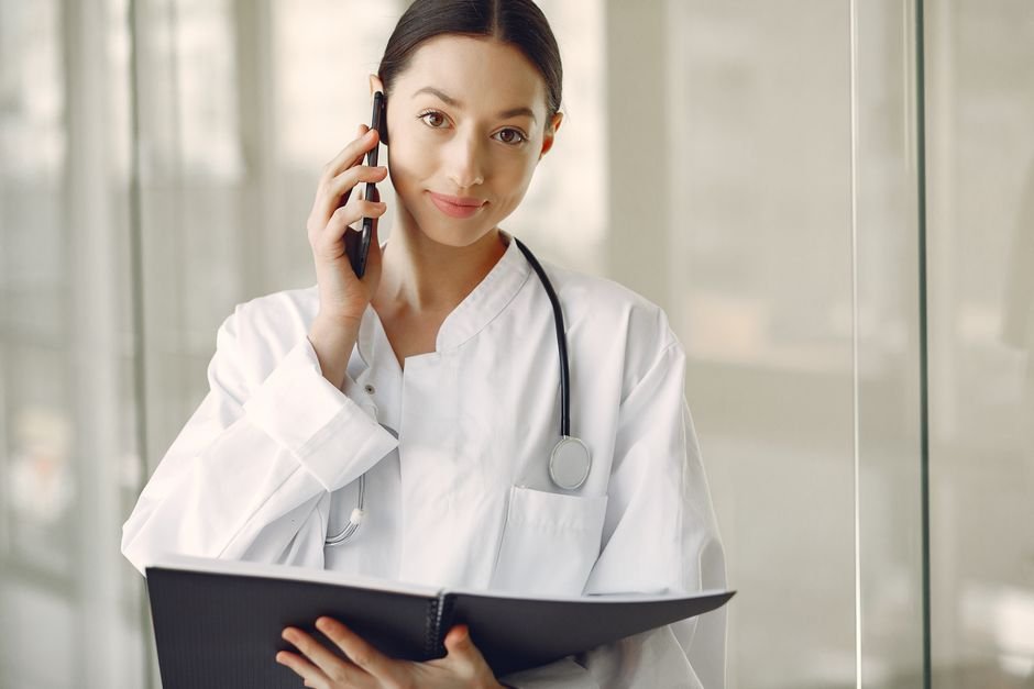 Medical billing specialist coordinating benefits with a happy patient