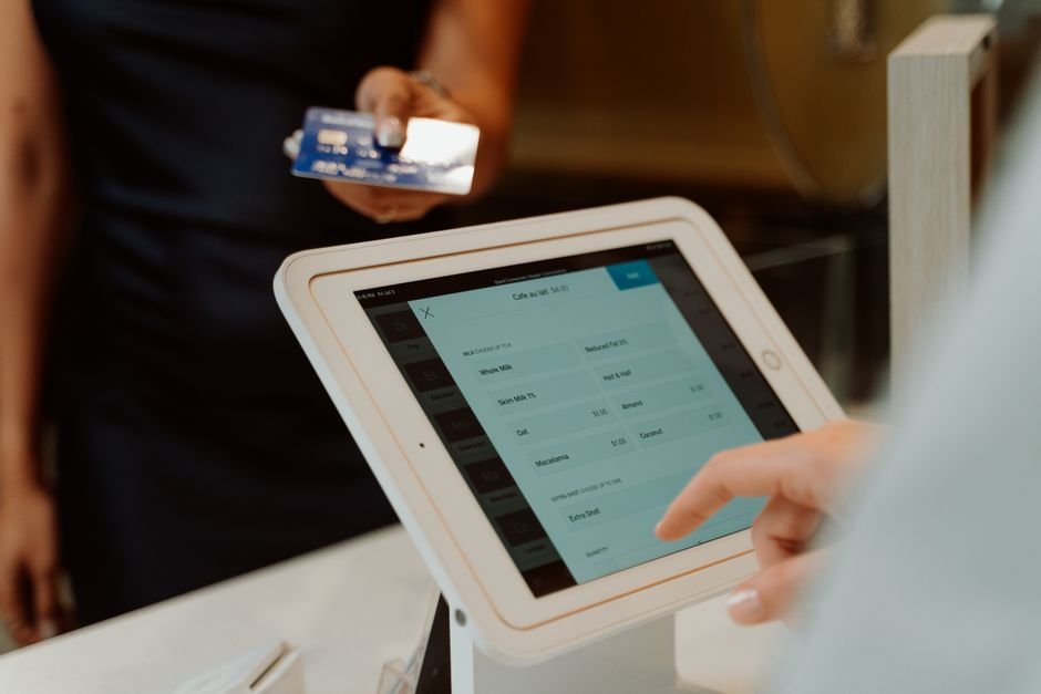 Close-up of a hand interacting with healthcare technology on a tablet for efficient billing.