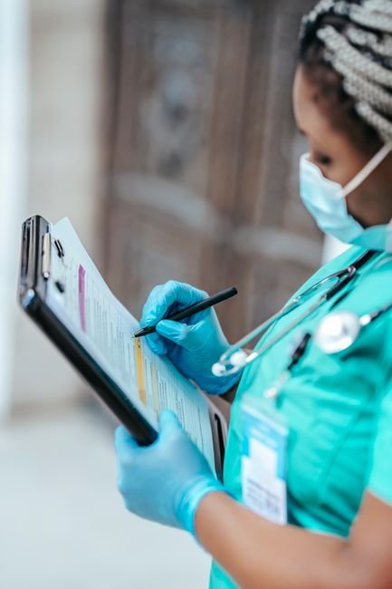 A medical professional accurately documents patient care details on a clipboard.