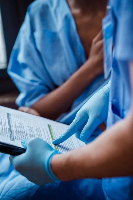 Medical professional reviewing patient files and NPI documentation for billing accuracy