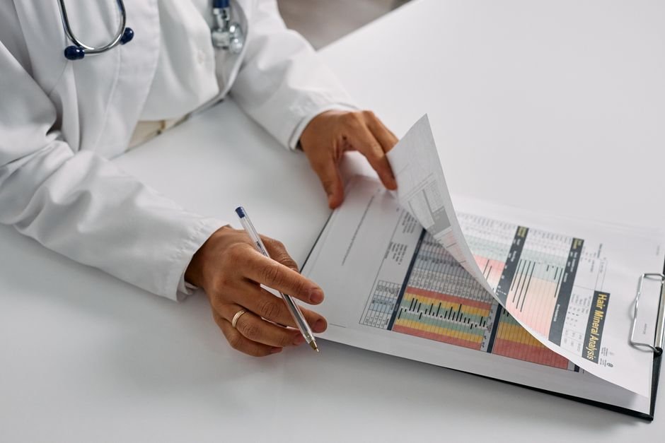 pexels photo 7578802.jpg Medical professional diligently checking patient reports and billing codes to avoid medical billing mistakes.