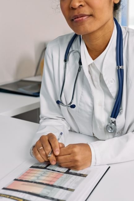 pexels photo 7578804.jpg Podiatrist and medical billing specialist reviewing patient charts for accurate coding