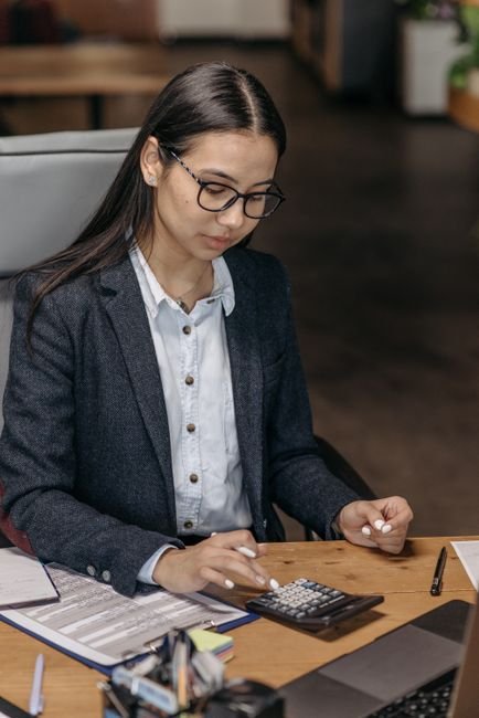 Dedicated medical billing professional accurately calculating financial data in an office.