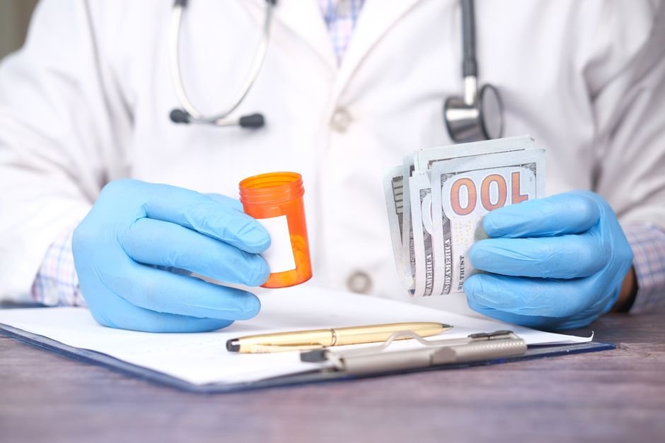 Hands holding cash and pill bottle, illustrating medical billing errors and financial adjustments