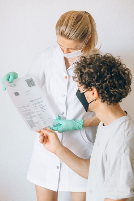 Healthcare professionals reviewing a document that outlines a new patient vs established patient coding decision workflow.