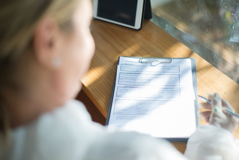 Healthcare professional meticulously completing complex provider enrollment forms.